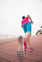 woman busy running on the promenade photo