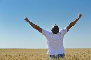 man in wheat field photo