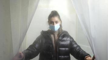 Woman entering human disinfection chamber video