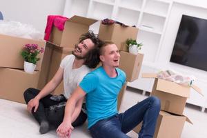 young  gay couple moving  in new house photo
