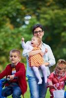 modern mother portrait  with kids in park photo