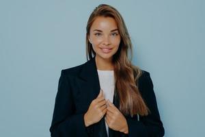 Pretty businesswoman in formal suit on light blue background photo