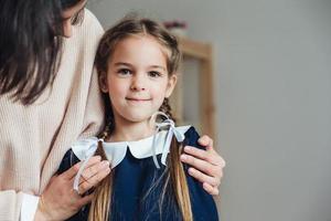 Happy woman embracing adorable girl photo