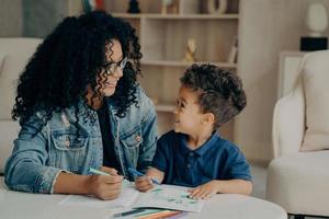 Beautiful afro american family of mother and son spending time at home photo