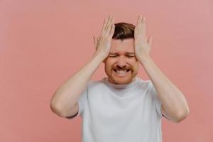 Young frustrated man worried about problems or failure photo