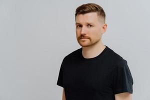 Young ginger man feeling sad and disappointed, looking at camera with frustrated face expression photo