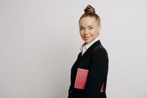 Bussiness woman in dark suit with confident look photo