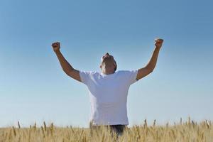 man in wheat field photo