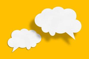 white cloud paper speech bubble shape against yellow background photo