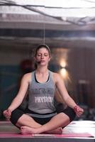 sportswoman doing yoga exercise and meditating photo