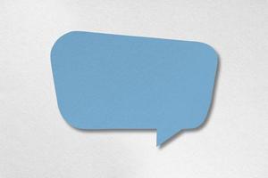 Speech balloon shaped blue paper isolated on white background. photo