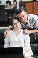 joyful couple relax and work on laptop computer at modern home photo