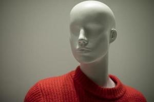 Mannequin in a red sweater. Shop window. Wool-bound clothing. photo