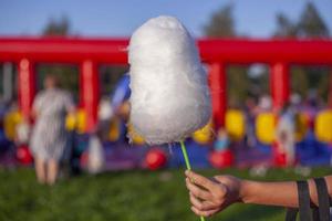 Cotton candy on stick. Sweetness on street. photo