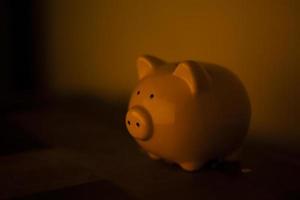 Piggy bank. Figure of pig for folding money. Symbol of financial well-being. Figure of animal is made of porcelain. photo