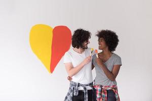 couple with painted heart on wall photo