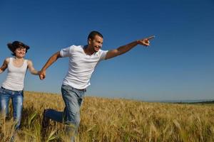 happy couple in wheat field photo