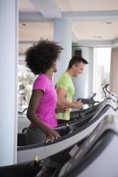 people exercisinng a cardio on treadmill in gym photo