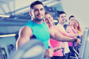 Group of people running on treadmills photo