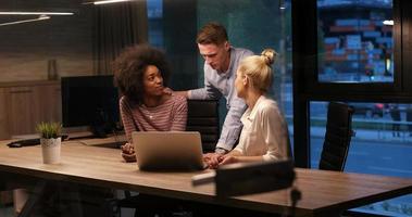 Multiethnic startup business team in night office photo