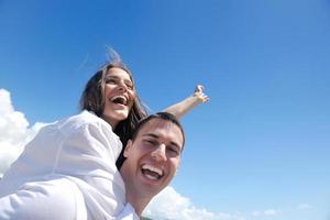 happy young couple have fun on beach photo