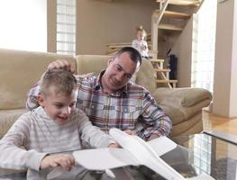father and son assembling airplane toy photo