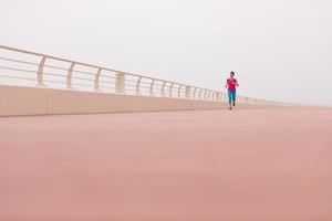 woman busy running on the promenade photo