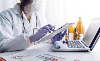 Medicine doctor and stethoscope touching icon medical network connection with modern interface on digital tablet in hospital background. Medical technology network concept photo