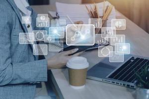 Big data analytics and business intelligence concept with chart and graph icons on a digital screen interface and a businessman hand in background photo