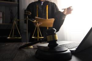 Business and lawyers discussing contract papers with brass scale on desk in office. Law, legal services, advice, justice and law concept picture with film grain effect photo