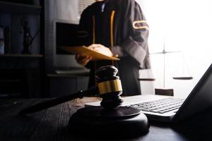 Business and lawyers discussing contract papers with brass scale on desk in office. Law, legal services, advice, justice and law concept picture with film grain effect photo