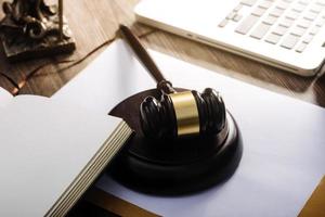 Business and lawyers discussing contract papers with brass scale on desk in office. Law, legal services, advice, justice and law concept picture with film grain effect photo