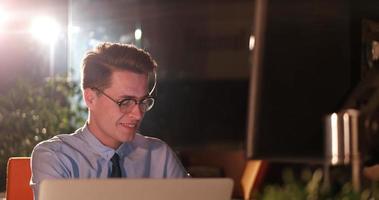 man working on computer in dark office photo