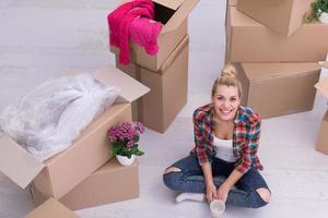 woman with many cardboard boxes sitting on floor photo