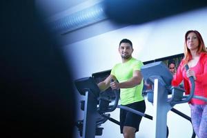 Group of people running on treadmills photo