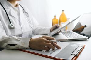 Medicine doctor and stethoscope touching icon medical network connection with modern interface on digital tablet in hospital background. Medical technology network concept photo