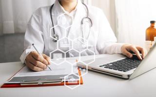 Medicine doctor and stethoscope touching icon medical network connection with modern interface on digital tablet in hospital background. Medical technology network concept photo