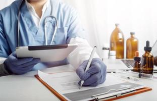 Medicine doctor and stethoscope touching icon medical network connection with modern interface on digital tablet in hospital background. Medical technology network concept photo