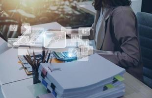 Big data analytics and business intelligence concept with chart and graph icons on a digital screen interface and a businessman hand in background photo