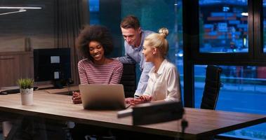 Multiethnic startup business team in night office photo
