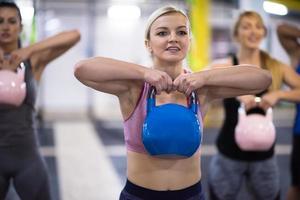 athletes doing exercises with kettlebells photo