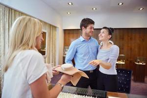 happy young couple in jewelry store photo