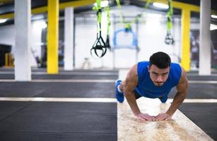 Young  man doing pushups photo