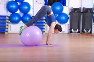 .happy young woman exercising in a gym photo