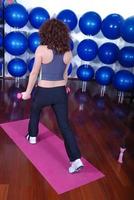 young pretty woman exercising in a fitness center photo