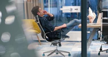 businessman sitting with legs on desk photo