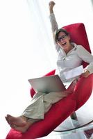 woman using a laptop computer at home photo