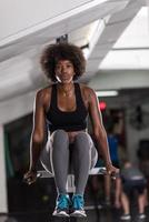 black woman doing parallel bars Exercise photo