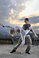 romantic urban couple dancing on top of the bulding photo