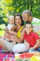 happy young couple with their children have fun at park photo